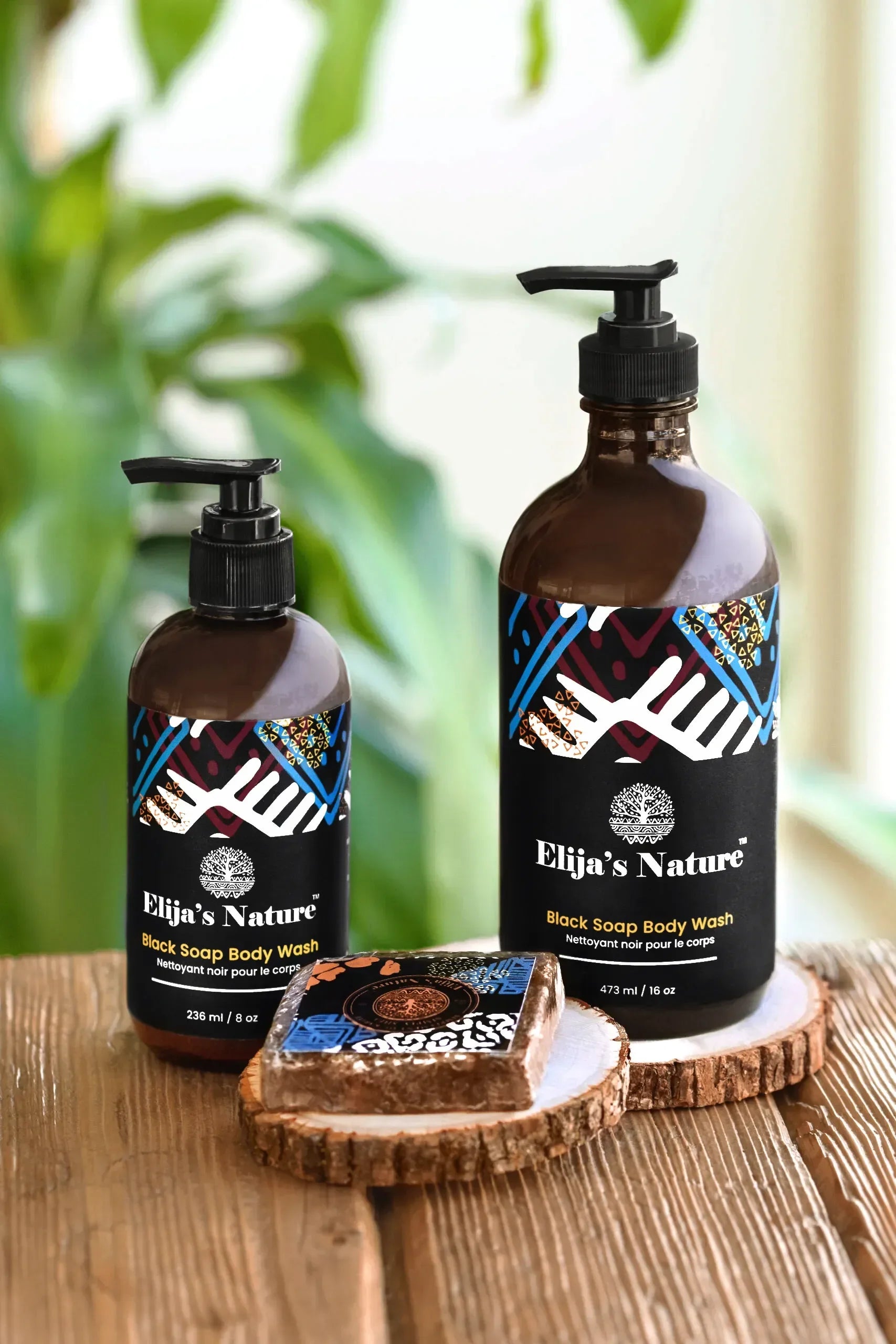 Group of Elija’s Nature body wash bottles with a Black Soap Bar in a bathroom