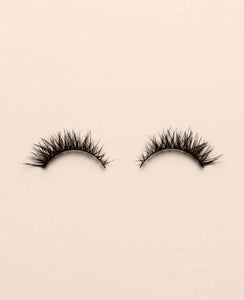 Pair of Silhouette false eyelashes on a beige background.