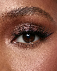 Close-up of a person's eye with dark eyeliner wearing Sweetie false lashes.