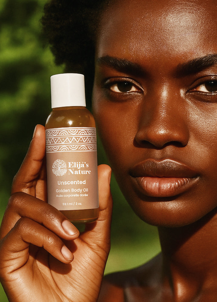 Golden Body Oil - #scent_Unscented #size_2oz - Woman holding an Unscented bottle of Elija’s Nature Golden Body Oil 2oz near her face